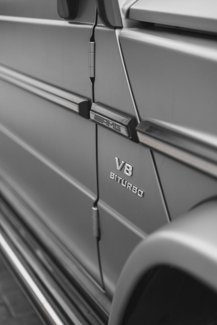 Detailed close-up of a Mercedes AMG with V8 Biturbo emblem, showcasing luxury vehicle design.